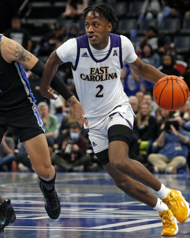 Jan 27, 2022; Memphis, Tennessee, USA; East Carolina Pirates guard Tristen Newton (2) dribbles as Memphis Tigers guard Lester Quinones (11) defends during the second half at FedExForum. Mandatory Credit: Petre Thomas-USA TODAY Sports